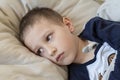 Pre-school sick boy lying in bed with a thermometer. Ill boy doesnÃ¢â¬â¢t feel well. - Image